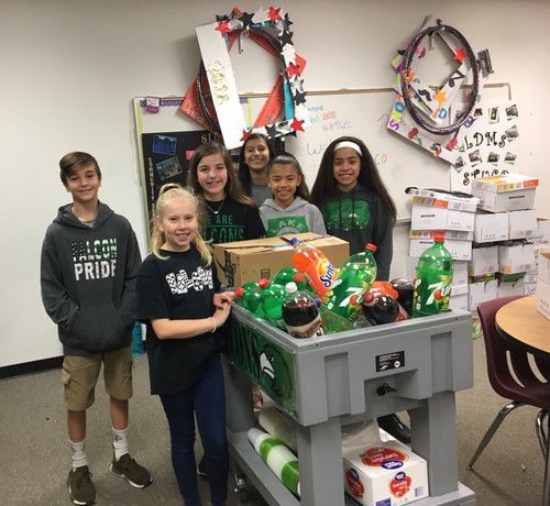 The Lake Dallas Middle School Student Council rolls around a snack and drink cart to classrooms in honor of Teacher Appreciation Week.